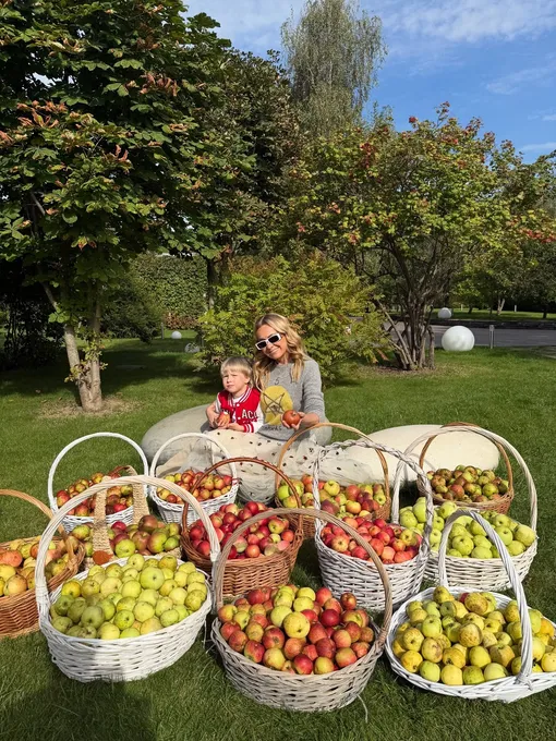 Яна Рудковская с сыном Арсением и урожаем яблок из своего сада